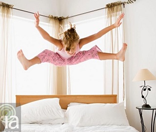 girl-jumping-on-bed-myria