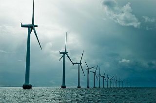 Windmills in a row on cloudy weather, wide shot, denmark